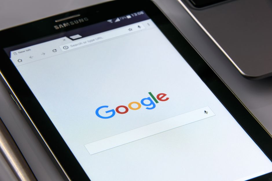 手に持った端末にGoogleの検索画面が表示されているイメージ画像